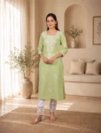 bhavini-pastel-green-white-embroidered-kurta-set-front-walking-view-sunlit-lounge-casual-ethnic-wear