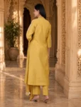 bhavini-mustard-yellow-white-embroidered-kurta-set-dotted-dupatta-elegant-pose-heritage-courtyard-festive-wear