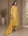 bhavini-mustard-yellow-white-embroidered-kurta-set-front-view-heritage-arch-location-festive-wear