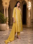 bhavini-mustard-yellow-white-embroidered-kurta-set-dotted-dupatta-elegant-pose-heritage-courtyard-festive-wear