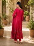 bhavini-red-gold-embroidered-anarkali-suit-standingpose-courtyard-occasionwear
