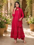 bhavini-red-gold-embroidered-anarkali-suit-standingpose-courtyard-occasionwear