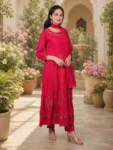 bhavini-red-gold-embroidered-anarkali-suit-standingpose-courtyard-occasionwear