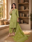 bhavini-olive-green-floral-print-suit-standingpose-livingroom-casualwear